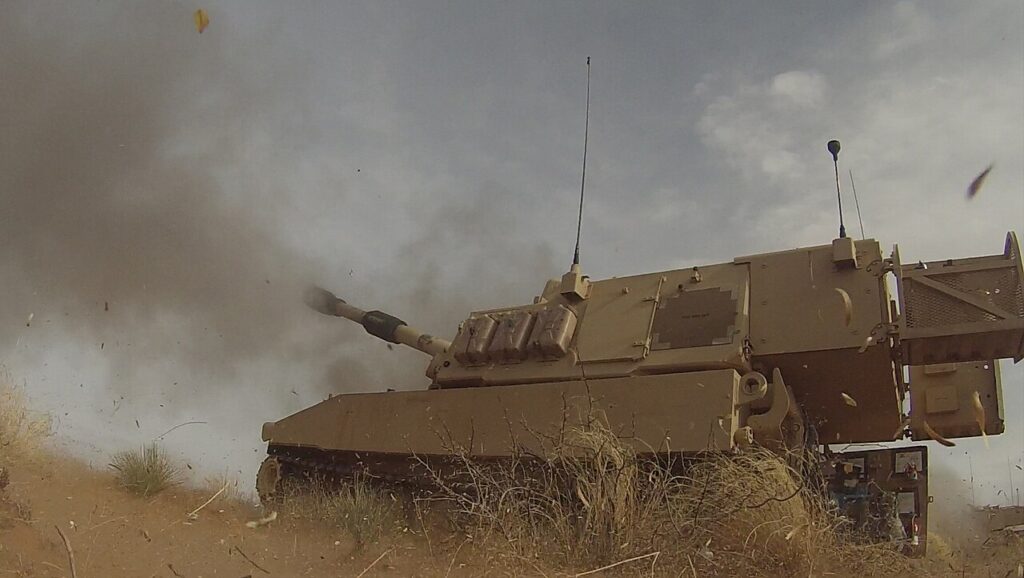 An Army M109A6 howitzer crew trains with the M1156 Precision Guidance Kit in 2014. The kit shown is the standard PGK, not the long-range kit.