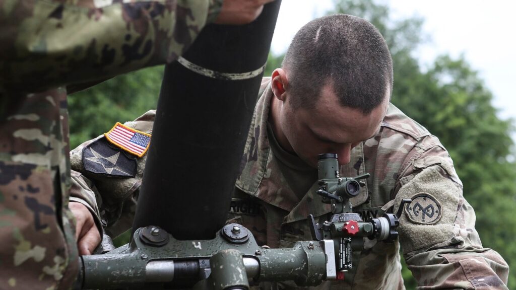 A New York Army National Guard soldier with the 2nd Battalion, 108th Infantry Regiment, zeroes an M120 120mm mortar at Fort Drum in 2019.