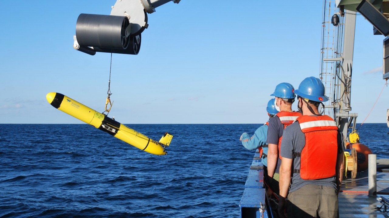 Yellow Slocum ocean glider lifted aboard a research ship