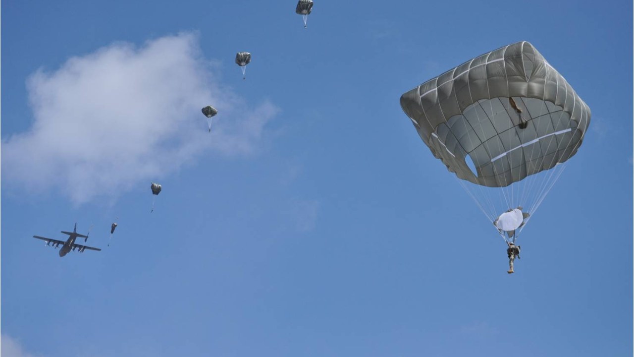 Paratroopers descending under T-11 parachute canopies