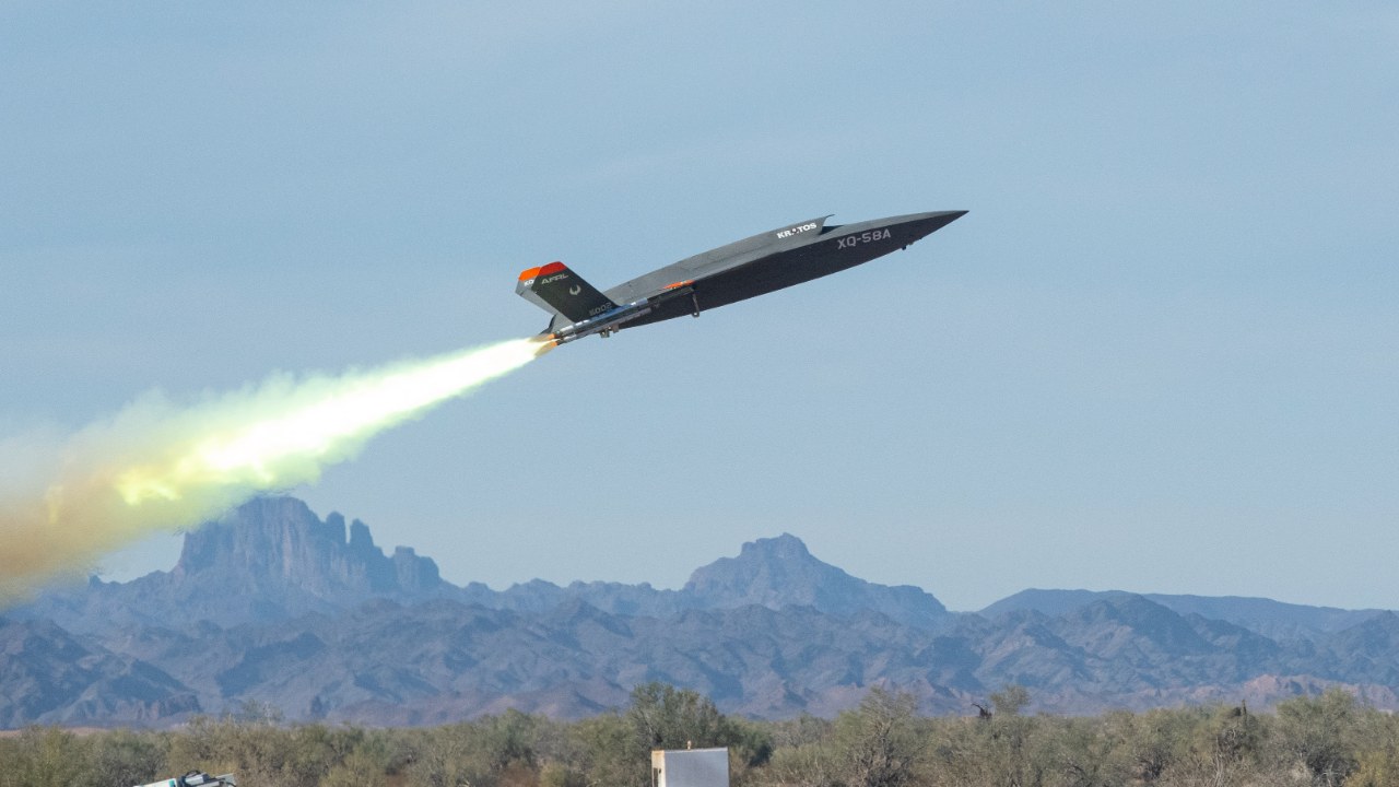 XQ-58A Valkyrie drone launching with a rocket booster