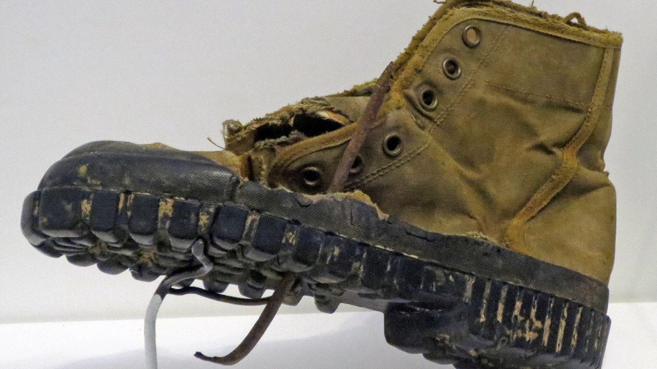 Worn Vietnam War jungle boot with canvas upper and lugged sole