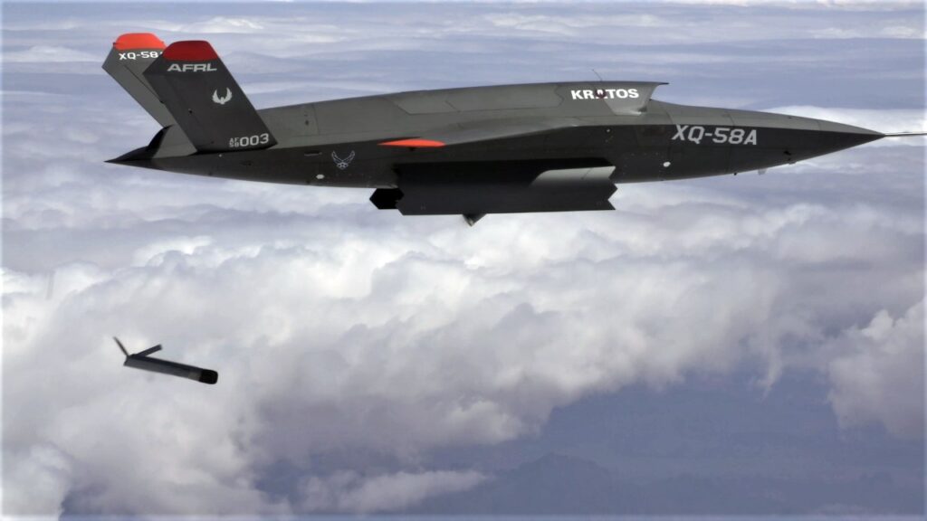 Small drone separating from an XQ-58A Valkyrie in flight