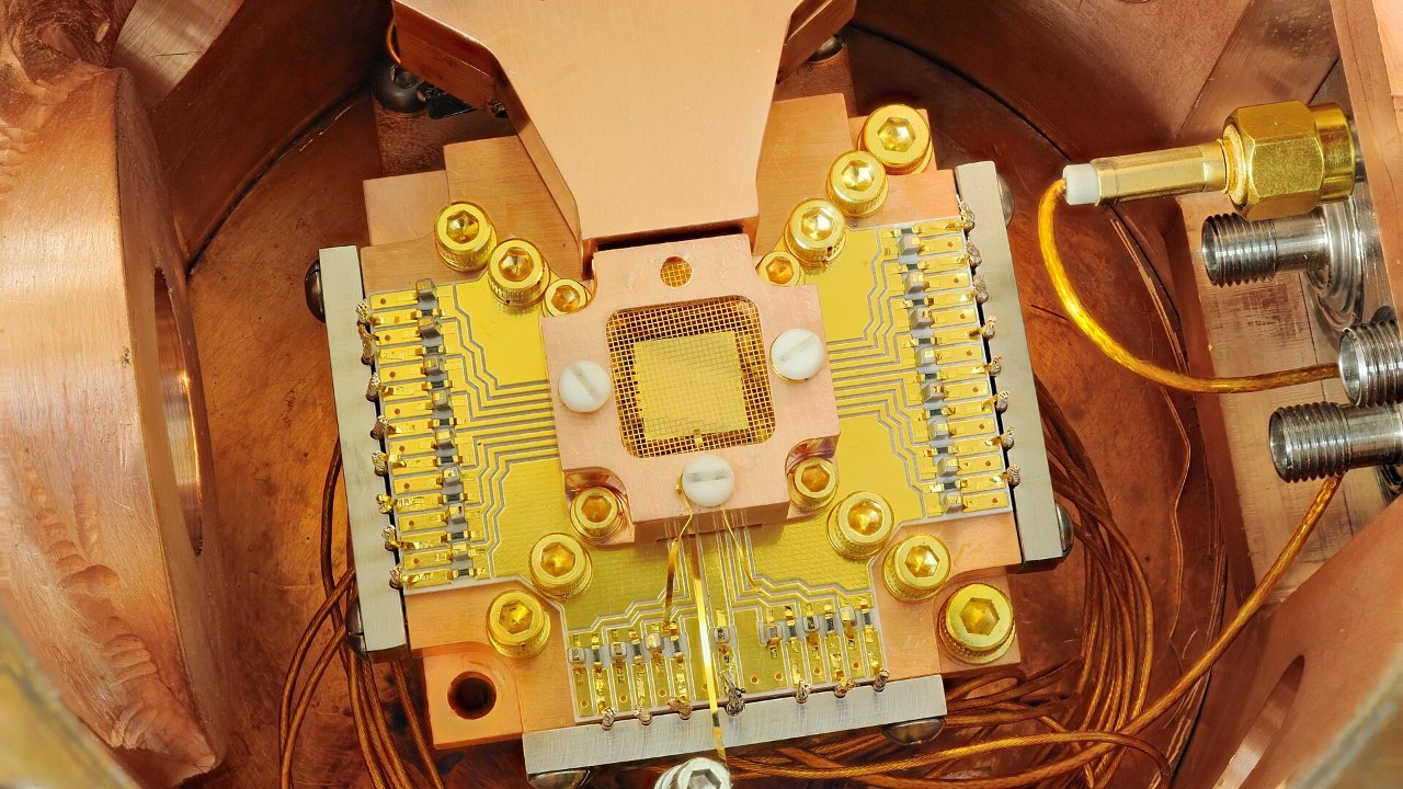 Gold ion-trap chip inside a copper quantum experiment housing