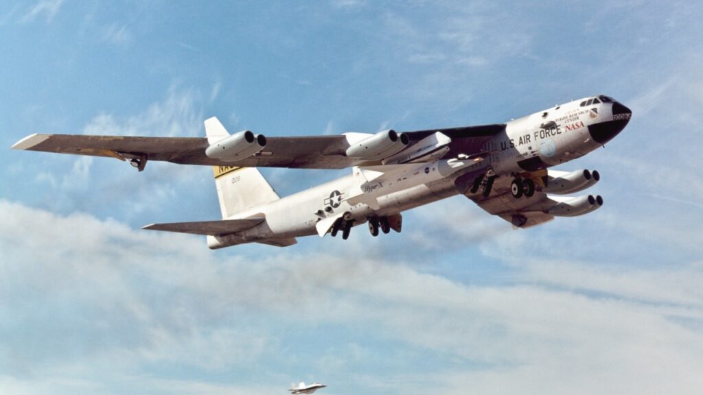 NASA B-52B in flight carrying the X-43A and Pegasus rocket under its wing