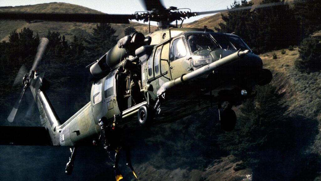 An HH-60G Pave Hawk of the 129th Rescue Wing, California Air National Guard, hovers over the Pacific during a training flight