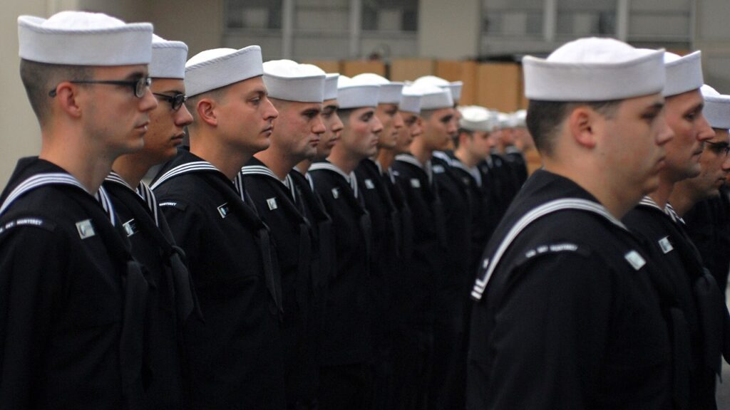 Sailors in Navy dress blue jumpers stand in formation in Monterey, Calif., on Nov. 5, 2009