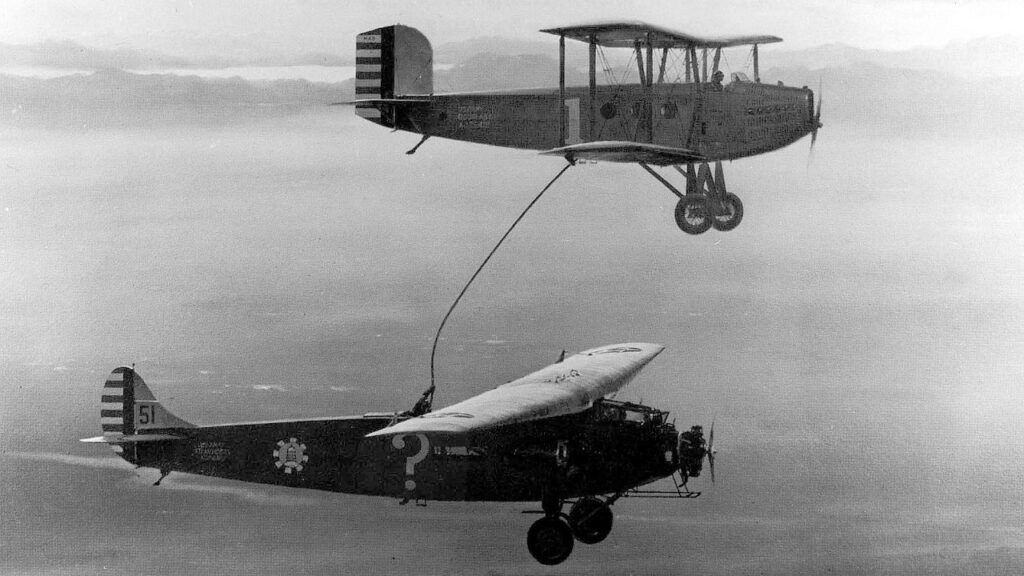 The Question Mark takes on fuel from a tanker aircraft flying above it during the January 1929 endurance flight