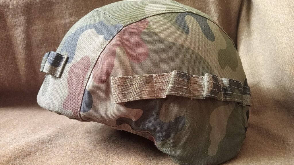 A Polish army helmet in green and brown Pantera camouflage cover